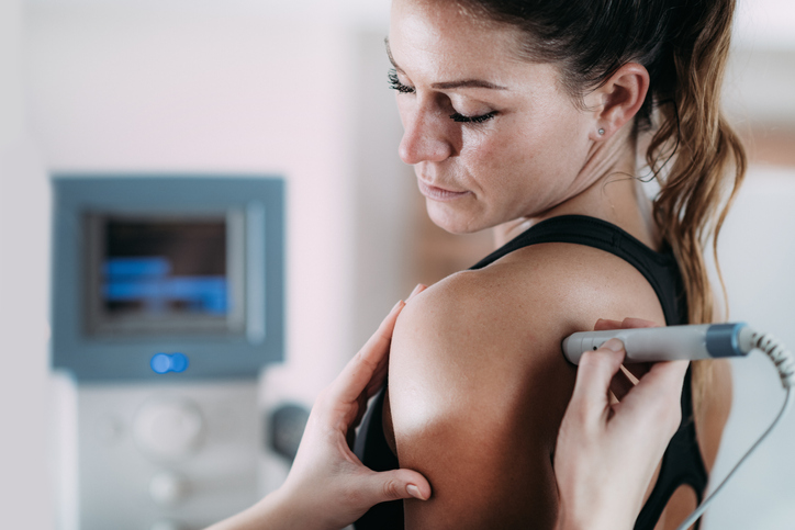 Ultrasound treatment on a girl's shoulder to treat shoulder pain Ultrasound treatment on a girl's shoulder to treat shoulder pain