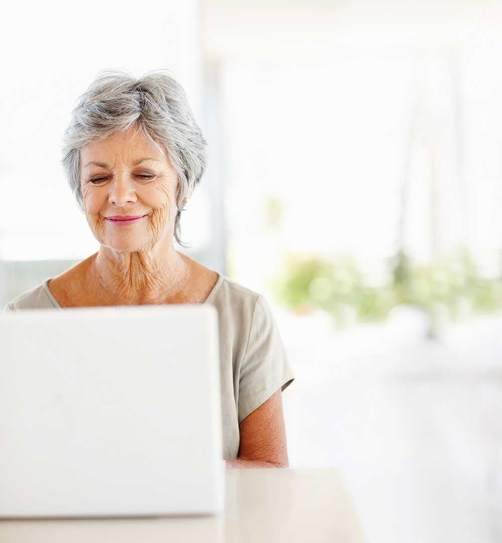 Lady having virtual physio consultation in front of computer Lady having virtual physio consultation in front of computer