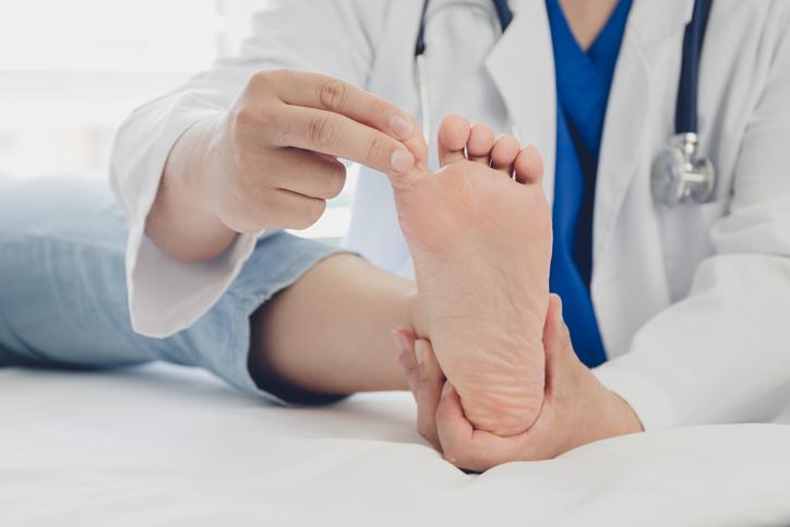Doctor examining a patient's diabetic foot Doctor examining a patient's diabetic foot