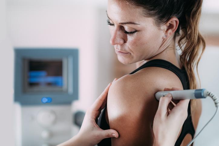 Ultrasound treatment on a girl's shoulder to treat shoulder pain Ultrasound treatment on a girl's shoulder to treat shoulder pain