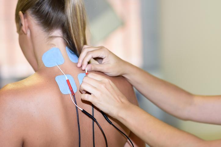 TENS treatment for neck pain on a female patient TENS treatment for neck pain on a female patient