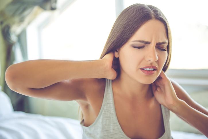 Lady getting out of bed with neck pain