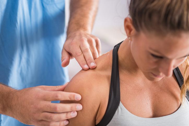 Physiotherapist manipulating should joint as treatment of shoulder pain