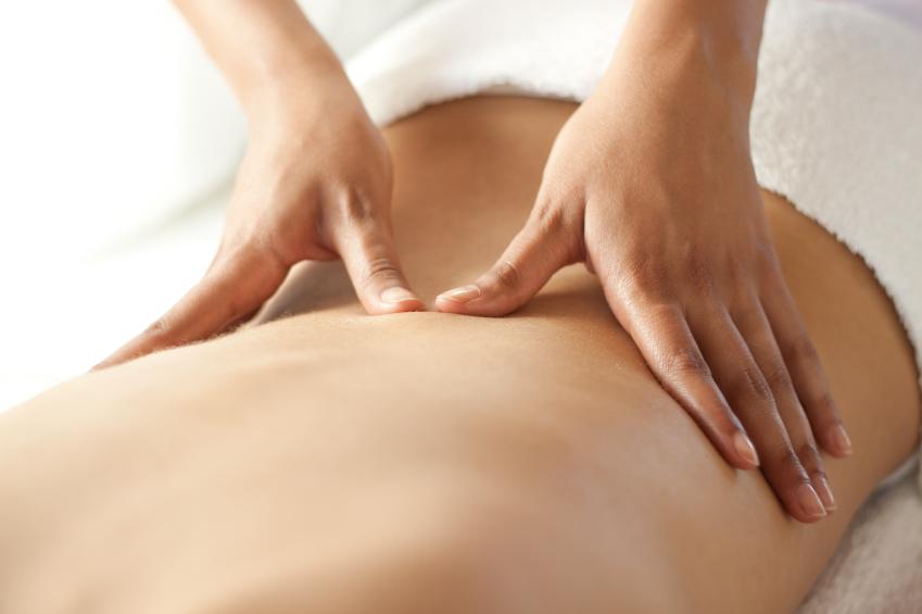 Sports massage to the back and physiotherapy Patient with back pain receiving sports massage and physiotherapy