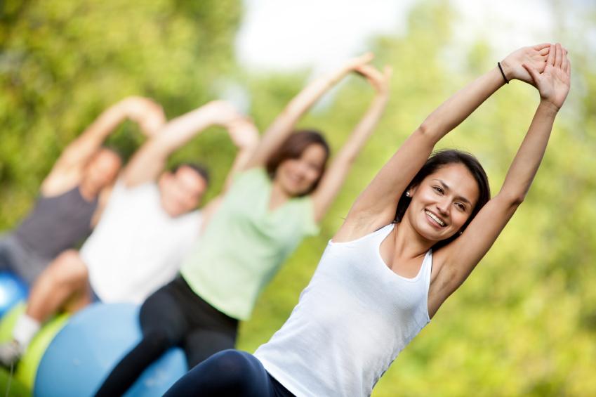 Group of people doing pilates with exercise ball